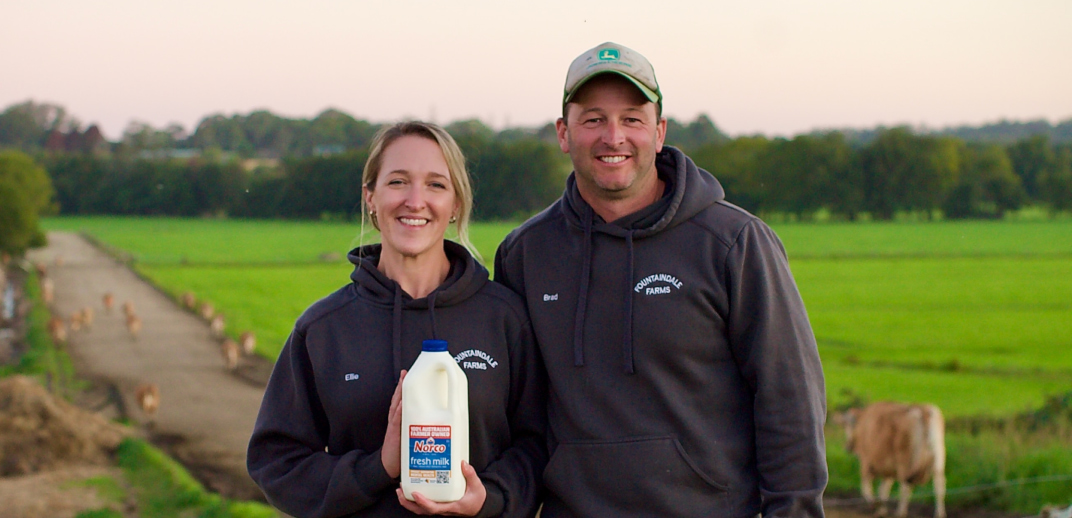 Couple holding Norco milk bottle